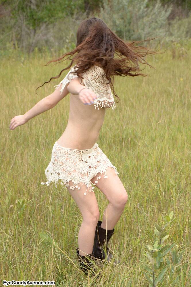 Skinny young girl Iva Nora teases her long hair in a field - #9