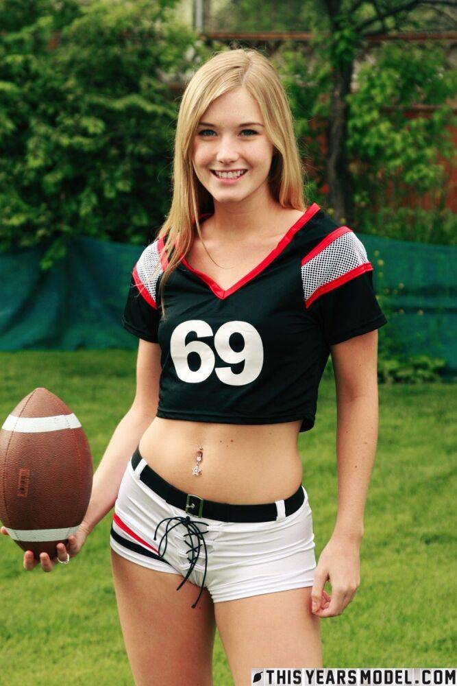 Beautiful blonde Jewel doffs sportswear to pose nude while holding a football - #13