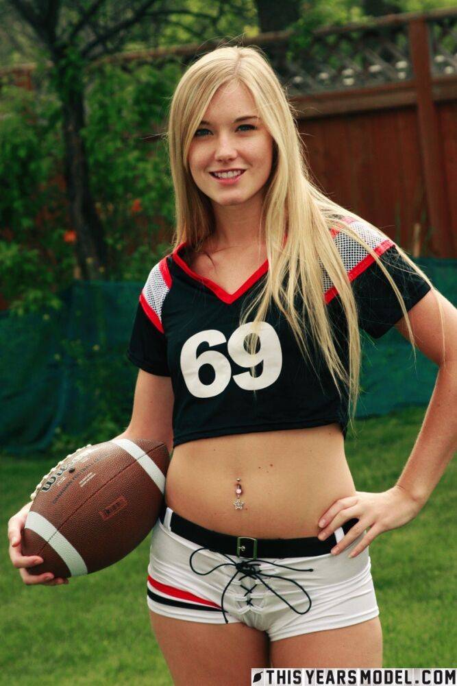 Beautiful blonde Jewel doffs sportswear to pose nude while holding a football - #15
