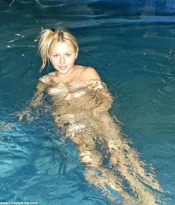 Young looking blonde removes a pink swimsuit to go skinny-dipping - #1