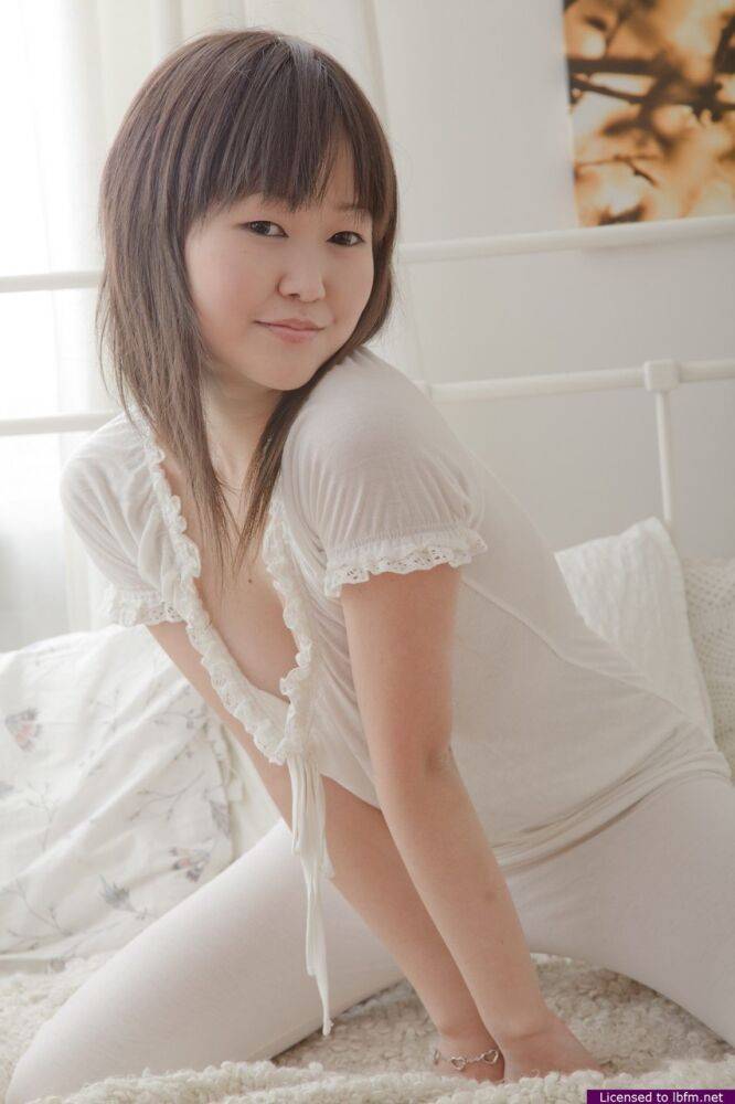 Adorable Asian teen Alicia pulls down her leggings to fondle her twat on a bed - #4