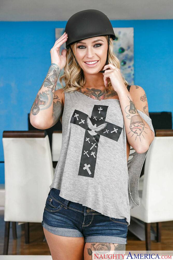 Tattooed blonde Kleio Valentien removing riding cap and clothes to pose naked - #13