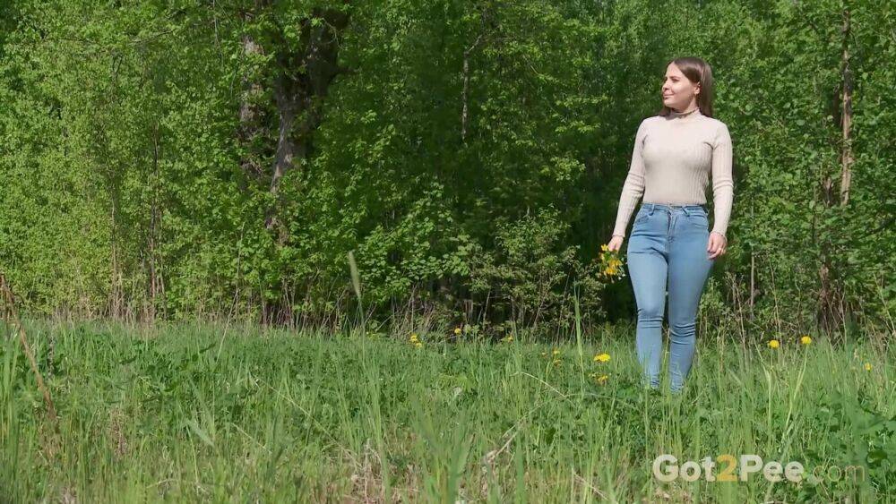 Solo girl Nastya pulls down tight jeans to pee on an old pad in a field - #15