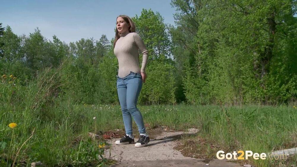 Solo girl Nastya pulls down tight jeans to pee on an old pad in a field - #8