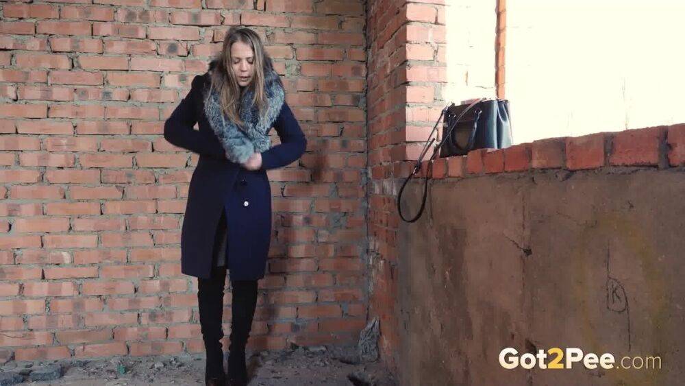 Distressed girl squats for an outdoor piss while wearing a heavy winter coat - #15