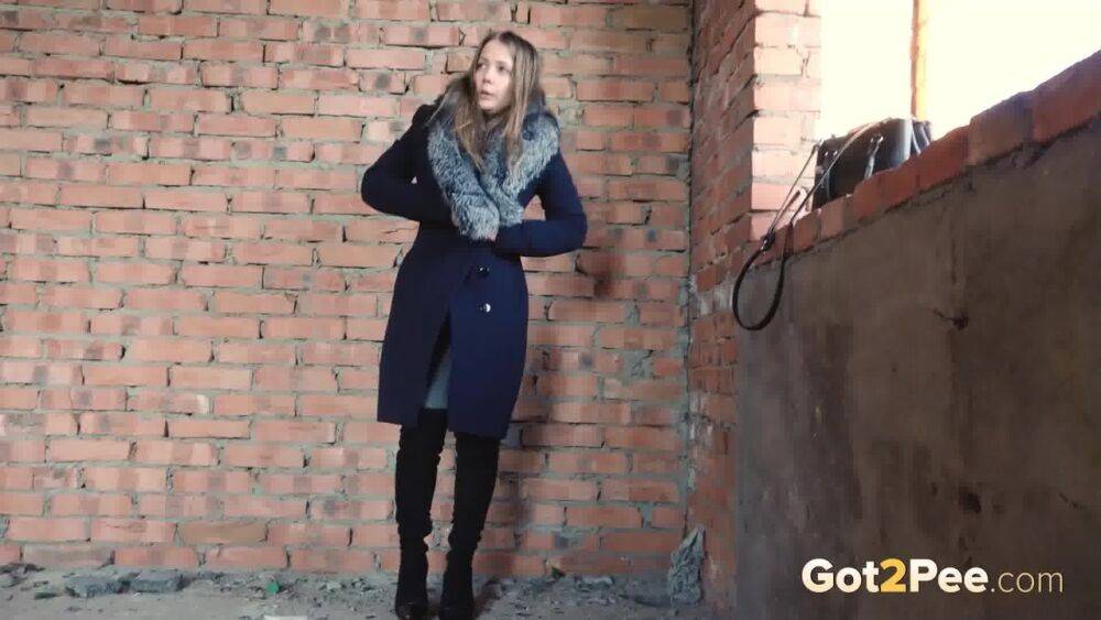 Distressed girl squats for an outdoor piss while wearing a heavy winter coat - #11