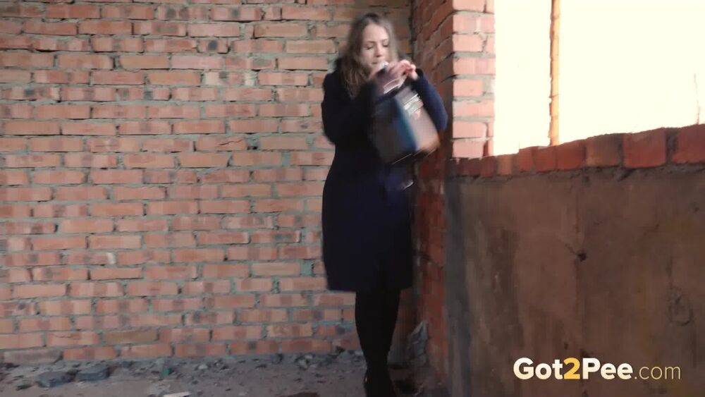 Distressed girl squats for an outdoor piss while wearing a heavy winter coat - #10