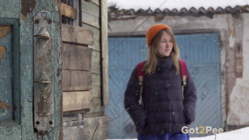 Cute girl pulls down jeans for an urgent piss on the steps of an old building - #10