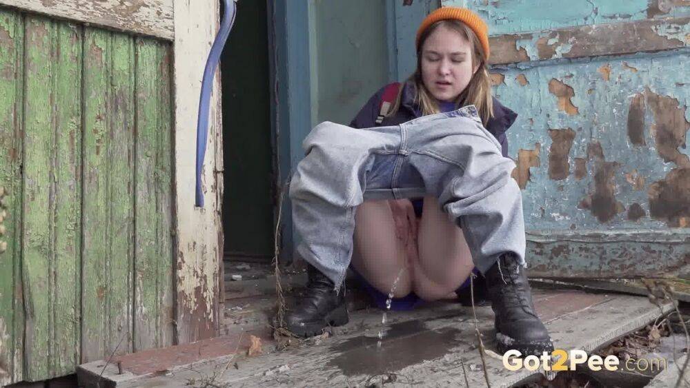 Cute girl pulls down jeans for an urgent piss on the steps of an old building - #9