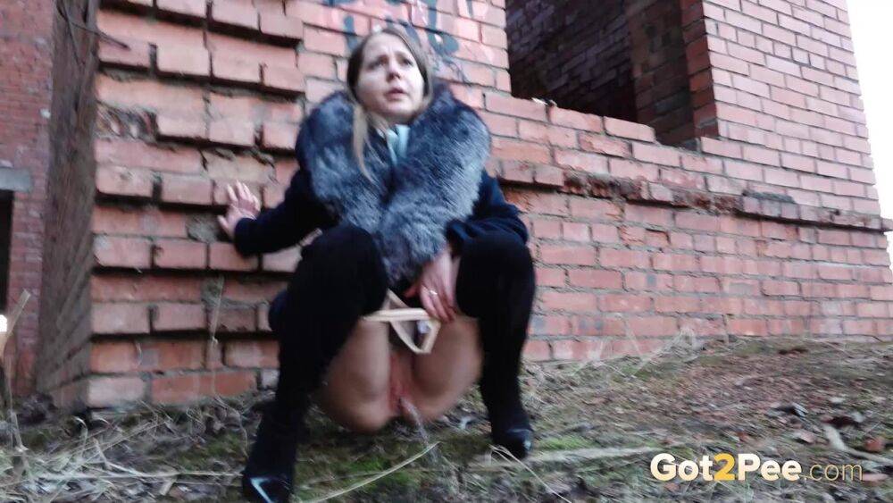 Distressed girl Nastya pulls down her tights to pee by an abandoned building - #9