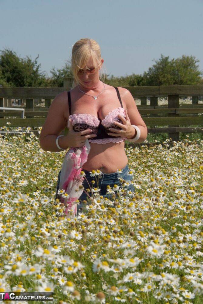 Overweight blonde Melody uncups her large boobs in a field of wild flowers - #3