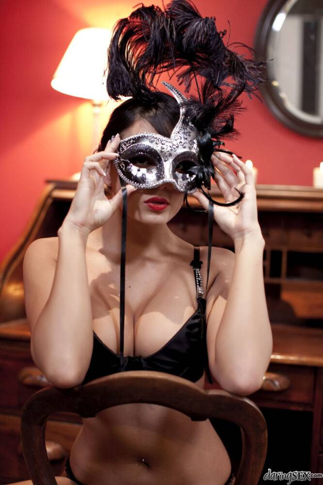 Brunette girl in her bra and underwear dons a mask to match her girlfriend | Photo: 3253135