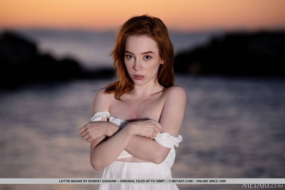 Young redhead Lottie Magne gets totally naked after walking a beach at sunset - #9