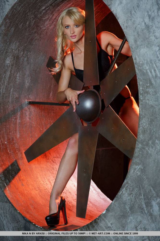 Sexy blonde teen Nika N strikes hot solo poses in front of a propeller - #9