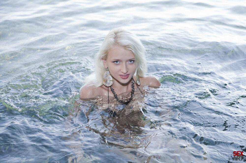 Young blonde Nika N takes off her bikini inside a sea cave - #2