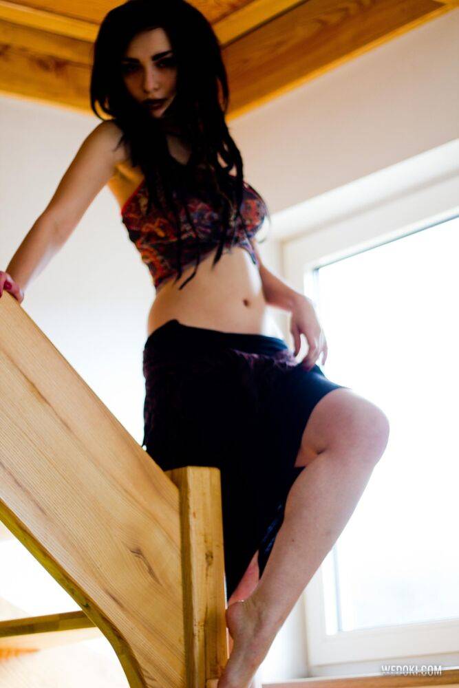 Dark haired beauty Alice Avreg gets dressed after posing nude on wooden stairs - #6