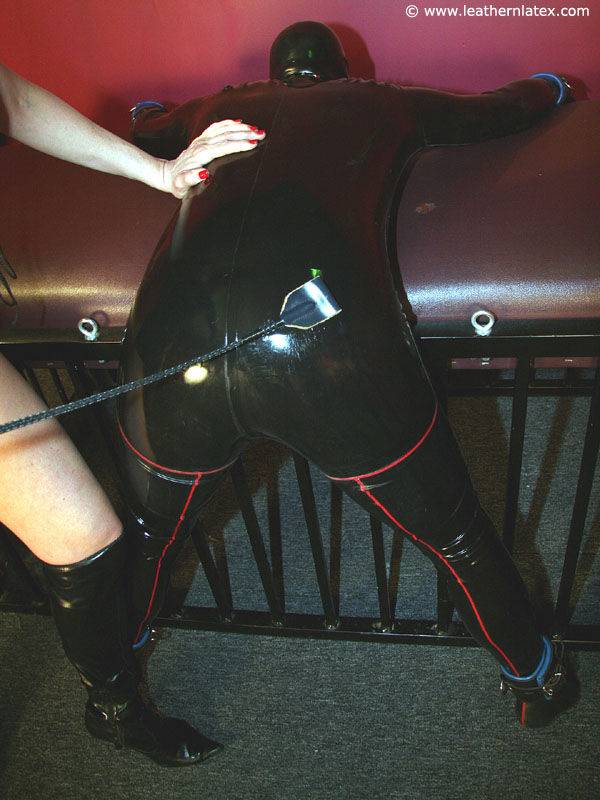 Mature blonde kinky Mistress in latex outfit and boots dominating a submissive - #12