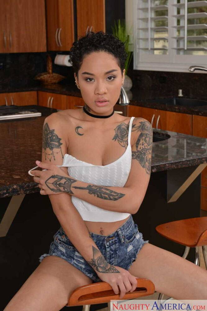 Exotic chick with tattoos peels off her white top and jean shorts to pose nude - #2