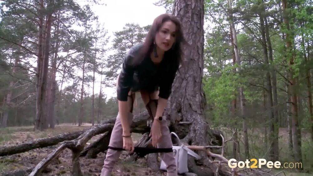 Solo girl Kristina K squats for a piss by a tree in OTK boots and nylons - #7