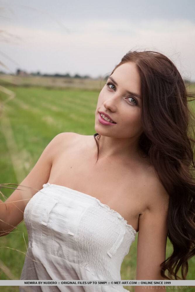 Beautiful brunette girl Niemira removes white dress to pose nude in hay field - #4