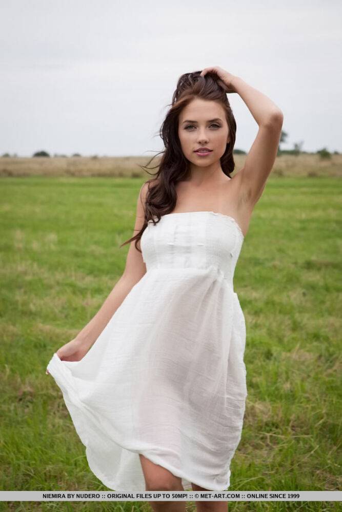 Beautiful brunette girl Niemira removes white dress to pose nude in hay field - #2