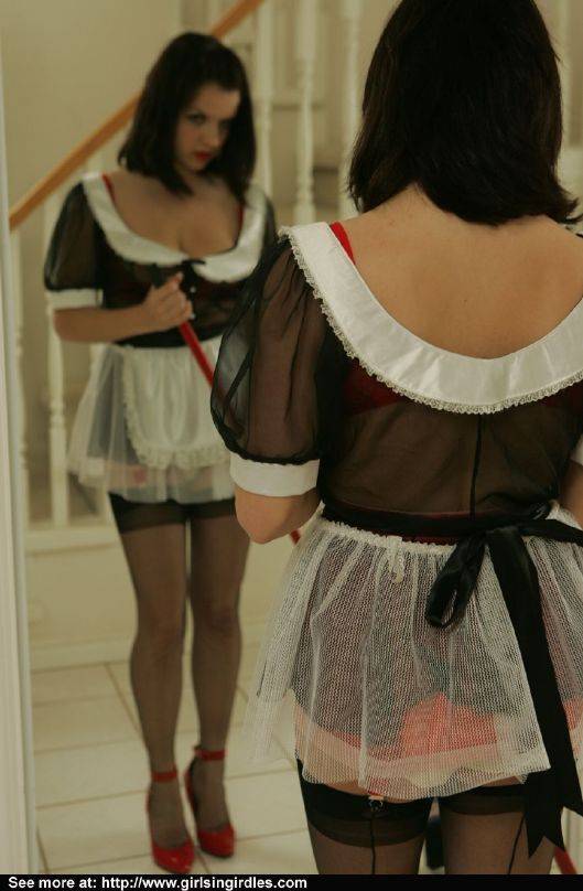 Brunette babe in stockings and maid uniform posing in front of the mirror - #12