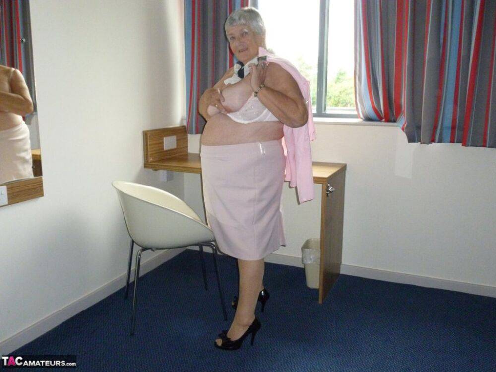 Obese old woman Grandma Libby lays her floppy tits on a desk while undressing - #7
