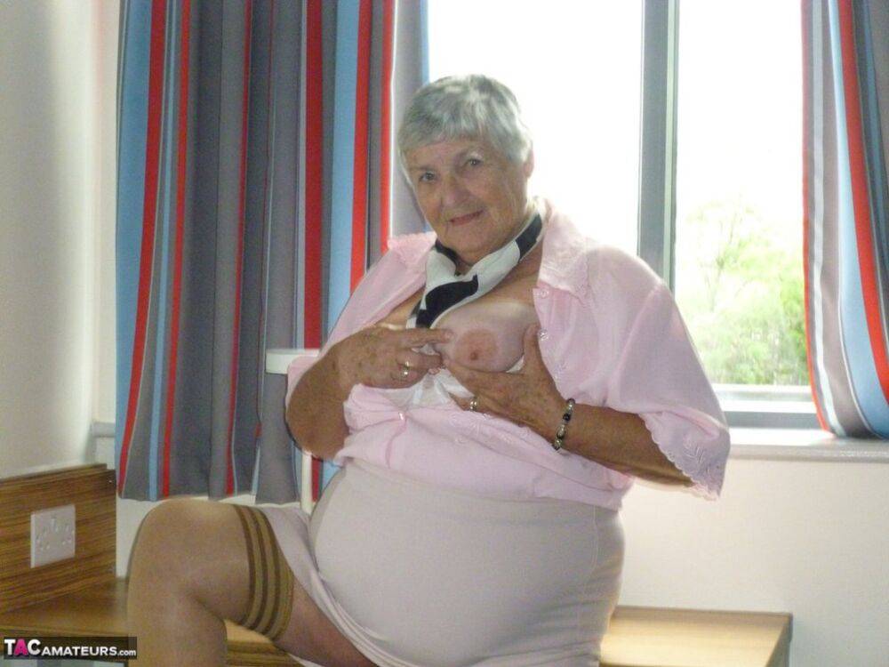 Obese old woman Grandma Libby lays her floppy tits on a desk while undressing - #6
