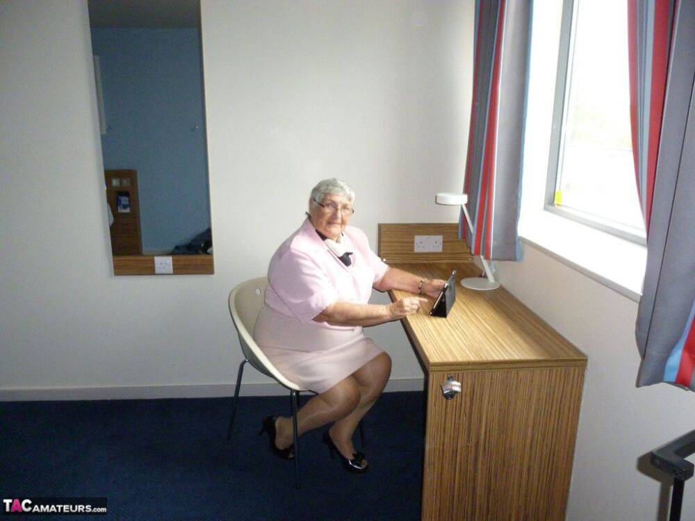 Obese old woman Grandma Libby lays her floppy tits on a desk while undressing - #3