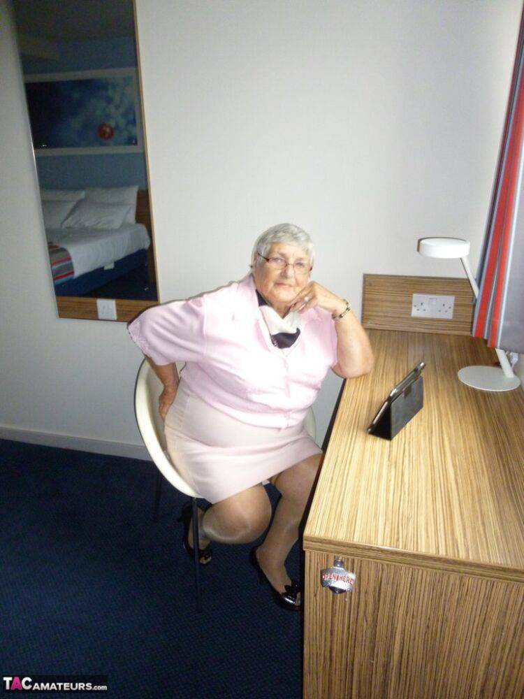 Obese old woman Grandma Libby lays her floppy tits on a desk while undressing - #14