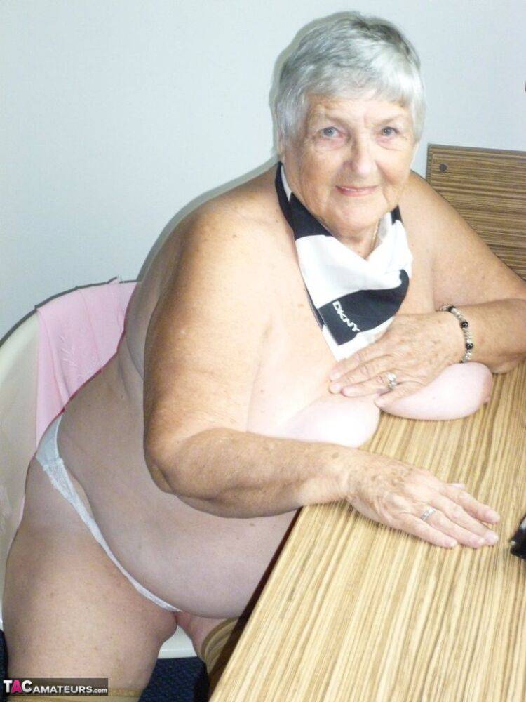 Obese old woman Grandma Libby lays her floppy tits on a desk while undressing - #12
