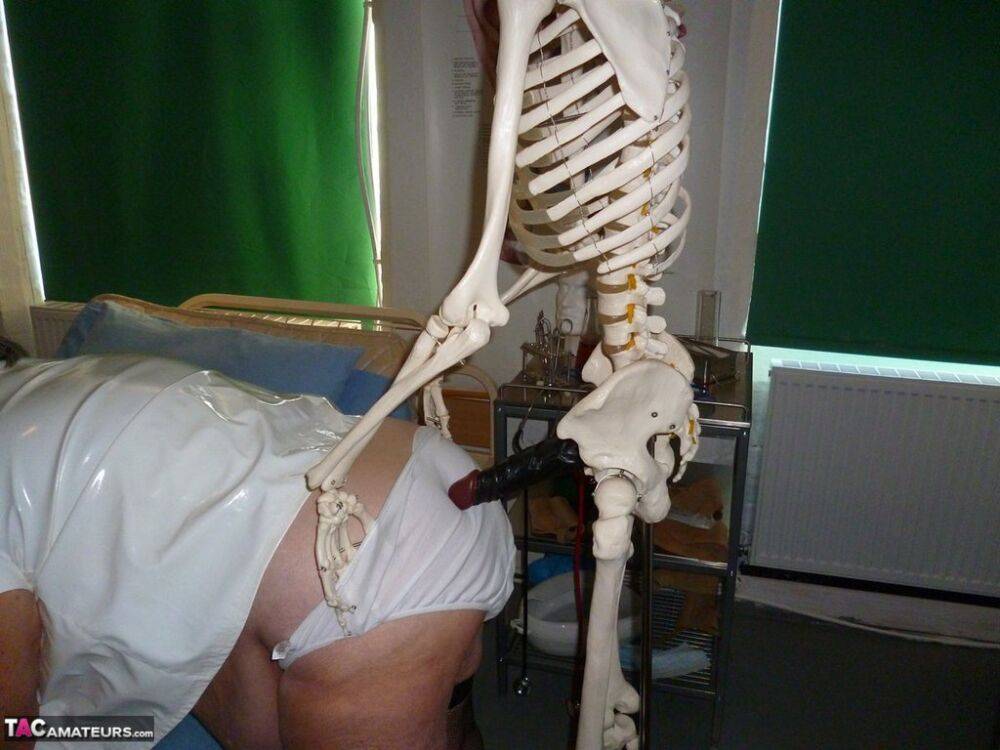 Fat old nurse Grandma Libby attaches a dildo to a skeleton for sexual relief - #1