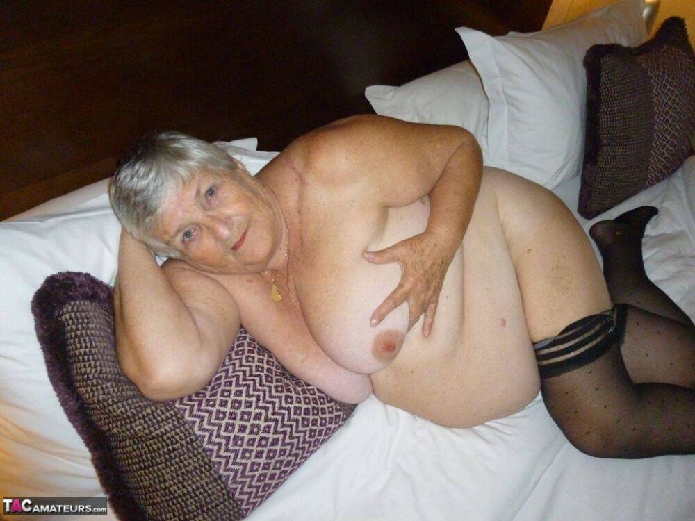 Old woman Grandma Libby displays her fat figure on a bed in sheer stockings - #14