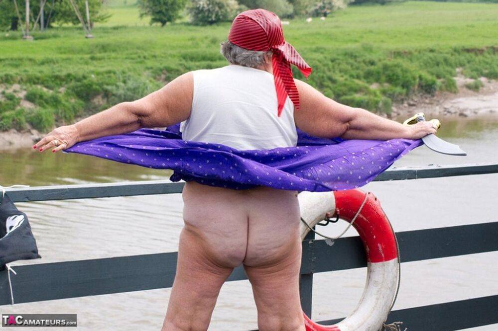 Fat British granny exposes herself on a bridge while sporting pirate attire - #1