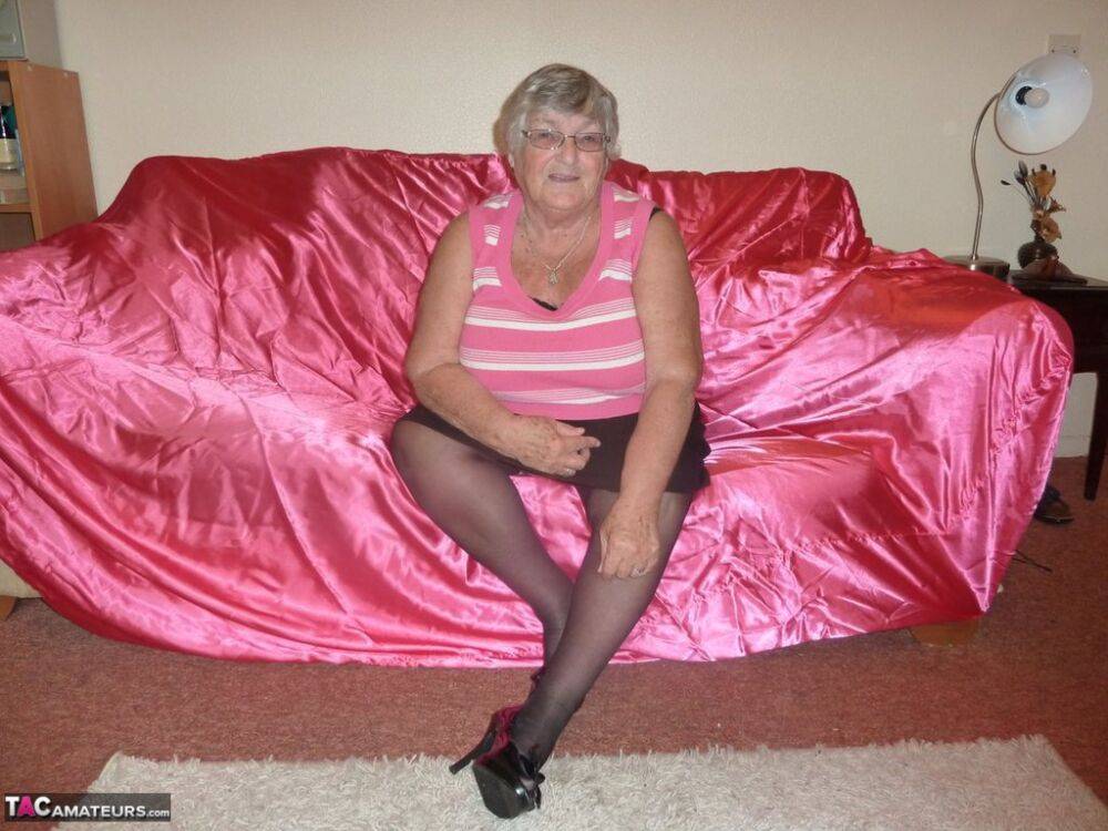 Obsese grandmother holds her fat rolls while stripping to black stockings - #3