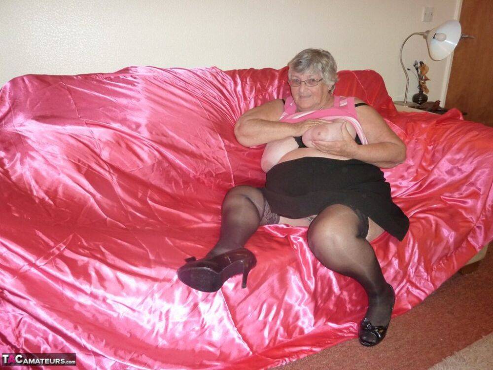 Obsese grandmother holds her fat rolls while stripping to black stockings - #5