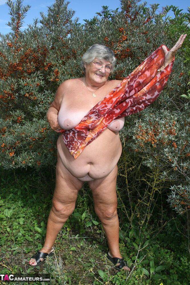 Obese nan Grandma Libby strips totally naked out by evergreen trees - #6