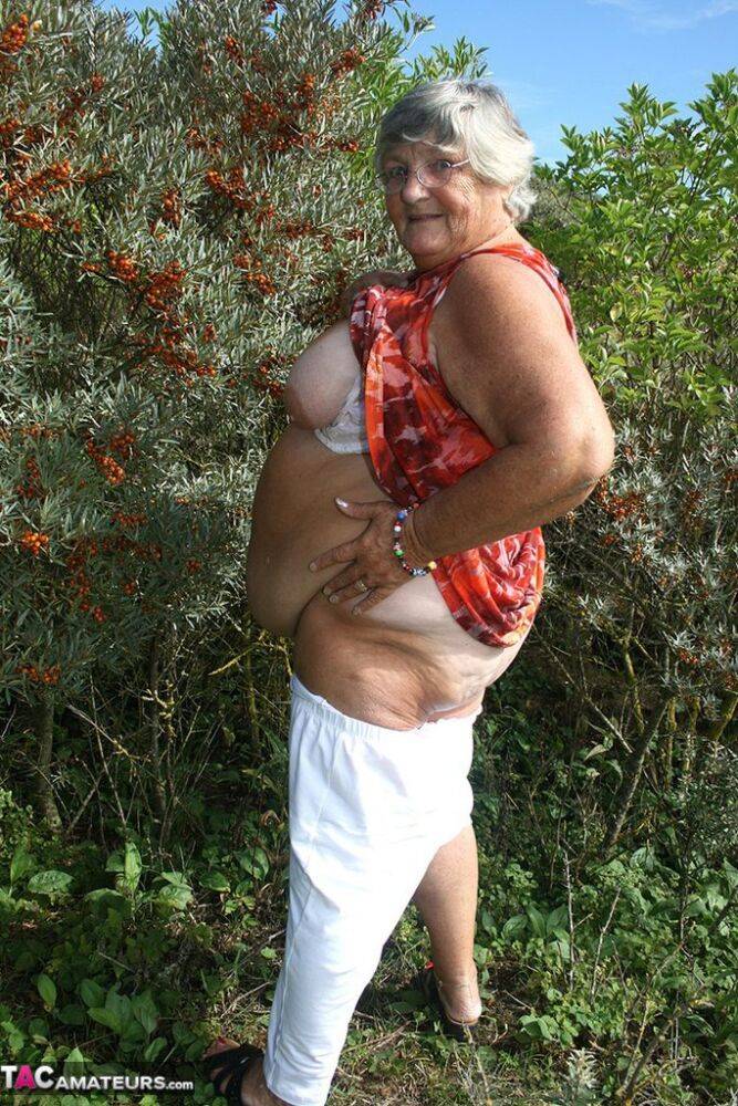 Obese nan Grandma Libby strips totally naked out by evergreen trees - #15