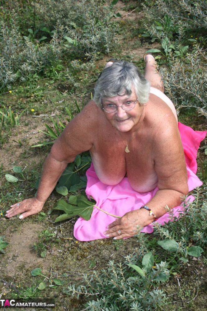 Fat British woman Grandma Libby gets naked on a towel upon scrubby ground - #9