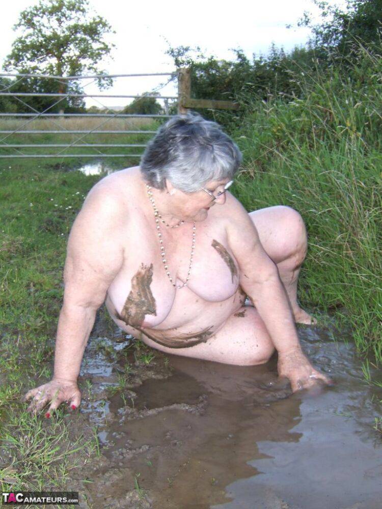 Fat nan Grandma Libby steps into a puddle before covering herself in mud - #1