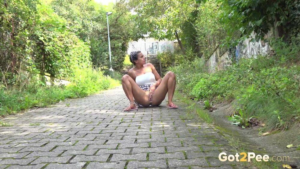 Distressed girl Chloe Lamour takes a piss on a cobblestone walkway - #1