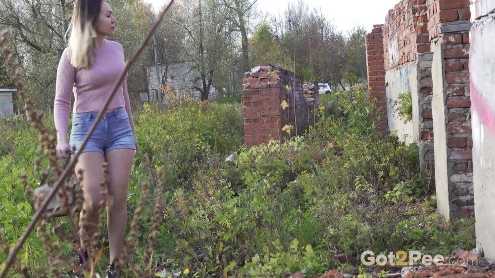 White girl ducks behind an old building to take an urgent piss - #2