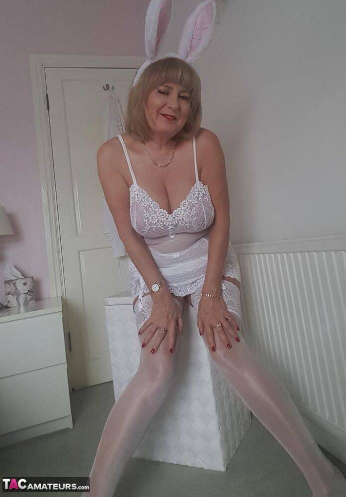 Smiley mature mom Lorna Blu offers her great big tits in white lace lingerie - #1