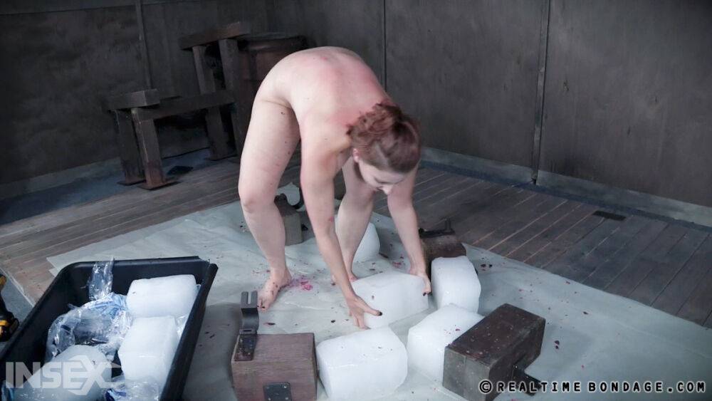 Tied up white girl Kel Bowie is lies on ice blocks while being doused with wax - #9