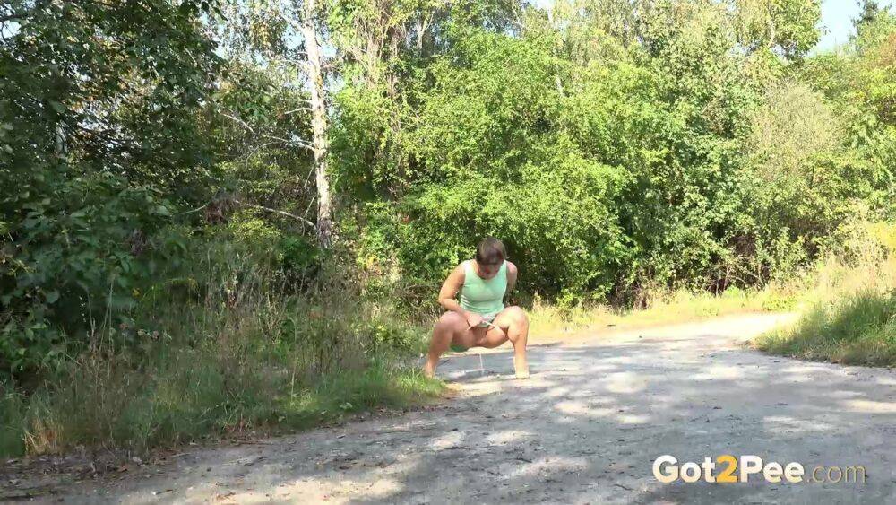 White chick pulls down her panties and squats for a piss on a country path - #12