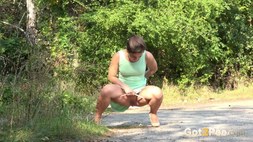 White chick pulls down her panties and squats for a piss on a country path - #5