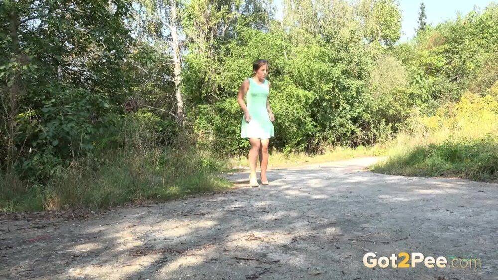 White chick pulls down her panties and squats for a piss on a country path - #13