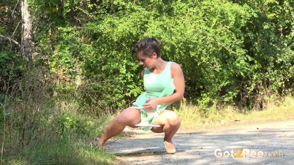 White chick pulls down her panties and squats for a piss on a country path - #10