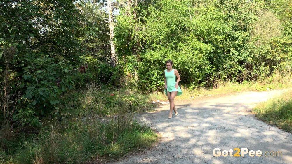 White chick pulls down her panties and squats for a piss on a country path - #7