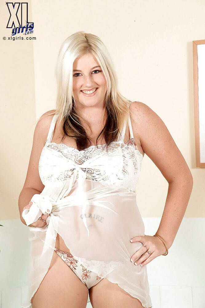 Busty blonde BBW teases us with her large body and incredible cleavage as she strips her sexy white lingerie. - #10